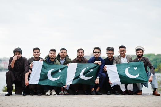 Group of pakistani man wearing traditional clothes salwar kameez or kurta with Pakistan flags. photo