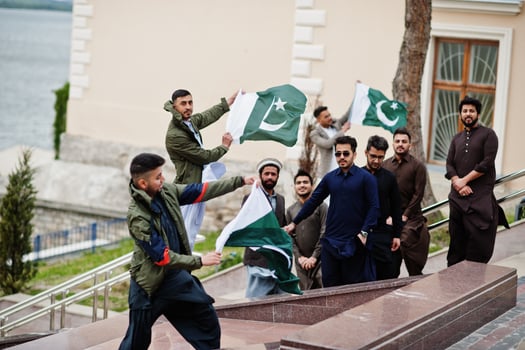Group of pakistani man wearing traditional clothes salwar kameez or kurta with Pakistan flags. photo
