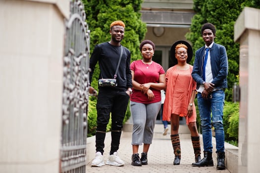 Four african friends having fun outdoors. Two black girls with guys. photo