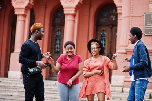 Four african friends having fun outdoors. Two black girls with guys. photo