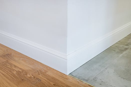 Detail of corner flooring with intricate crown molding and plinth. photo