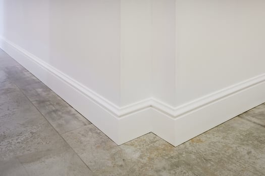 Detail of corner flooring with intricate crown molding and plinth. photo