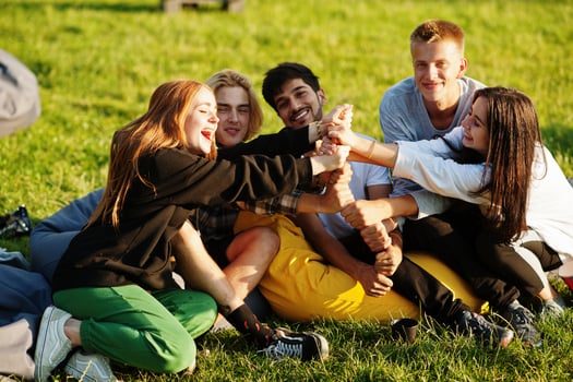 Young multi ethnic group of people watching movie at poof in open air cinema. photo