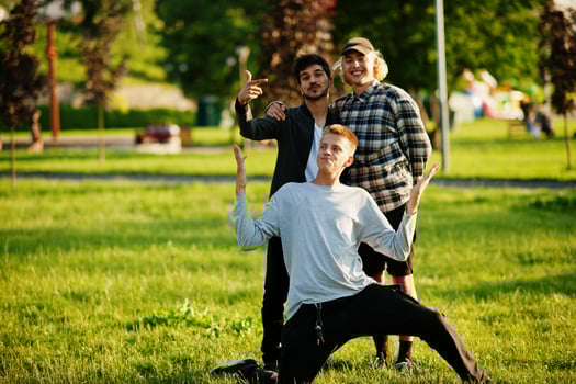 Three multi ethnic guys posed outdoor. photo