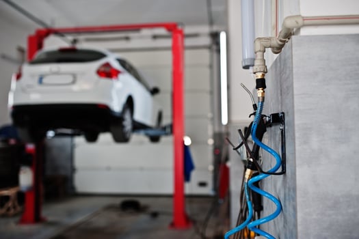 Car lifting in maintenance at garage service station. photo