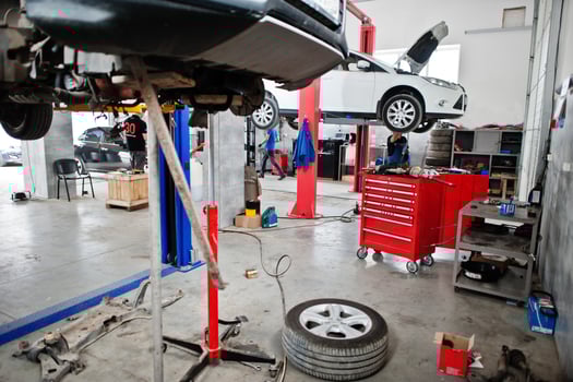Cars lifting in maintenance at garage service station. photo