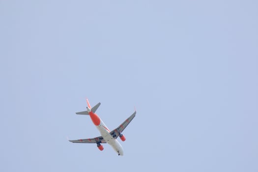 commercial aircraft flying under blue skies and arriving at the airport photo