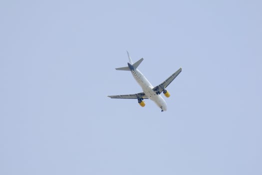commercial aircraft flying under blue skies and arriving at the airport photo