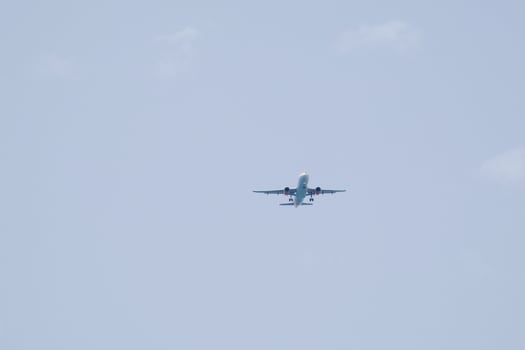 commercial aircraft flying under blue skies and arriving at the airport photo