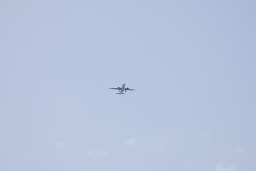 commercial aircraft flying under blue skies and arriving at the airport photo