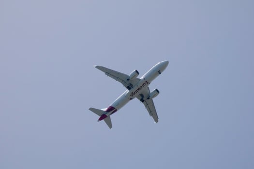 commercial aircraft flying under blue skies and arriving at the airport photo