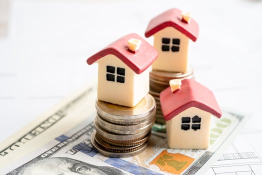 House with stack coins and uS dollar money on plan house, mortgage home loan finance concept. photo
