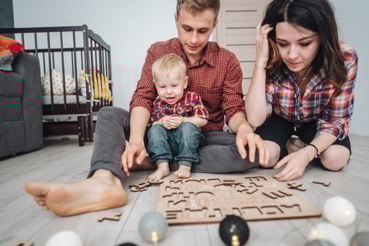 Happy family are playing together on the floor photo