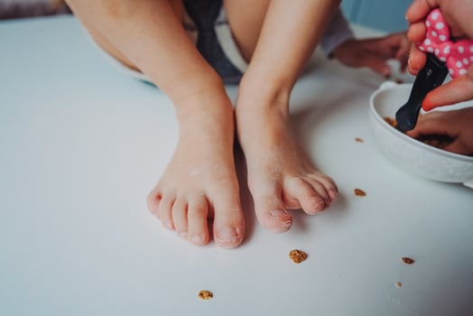 the legs of a small child in the flour photo