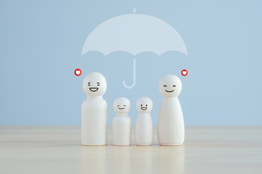 Life and health insurance. umbrella protecting family wooden model for  assurance life concept. photo