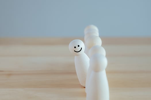 Individuality. Unique. Happy and enjoy stand out from group. Smiling figure among many crowd. Human development. Psychology Personality Concept. photo