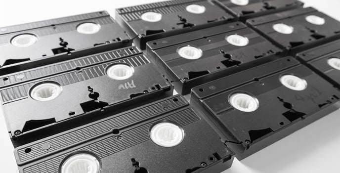 VHS tapes neatly arranged. Video Home System tape cassette on white background. photo