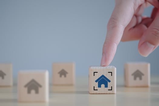 Real estate. House and property investment and asset management concept. Interest rates, loan mortgage, house tax. Hand select house icon on wooden block. photo