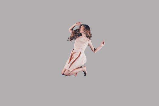 Life in motion. Studio shot of attractive young woman hovering in air photo
