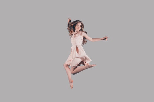 Levitation. Studio shot of attractive young woman hovering in air photo