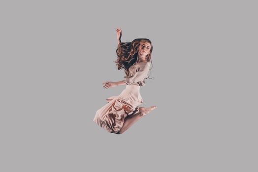 Moving free. Studio shot of attractive young woman hovering in air photo