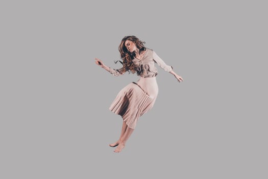 Freedom in every move. Studio shot of attractive young woman hovering in air photo