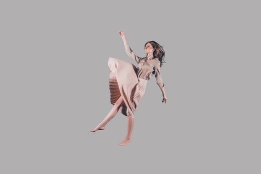 Hovering in the air. Studio shot of attractive young woman hovering in air photo