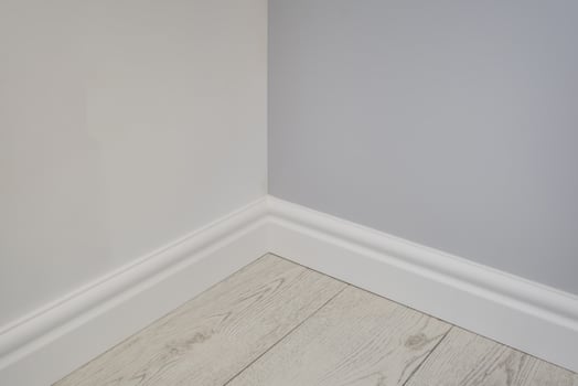 Detail of corner flooring with intricate crown molding and plinth. photo