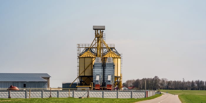 Modern Granary elevator. Silver silos on agro-processing and manufacturing plant for processing drying cleaning and storage of agricultural products, flour, cereals and grain. seed cleaning line photo
