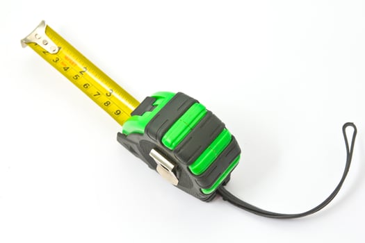 Single green and black tape measure, isolated over white photo