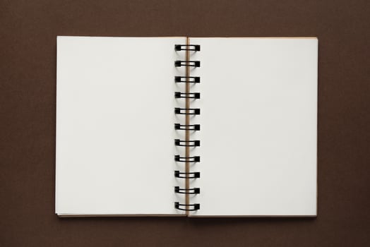 Top view of open empty notebook with cover from recycled paper on brown colorful background photo