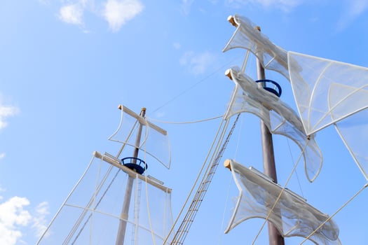 Sails of the boat against blue sky. photo