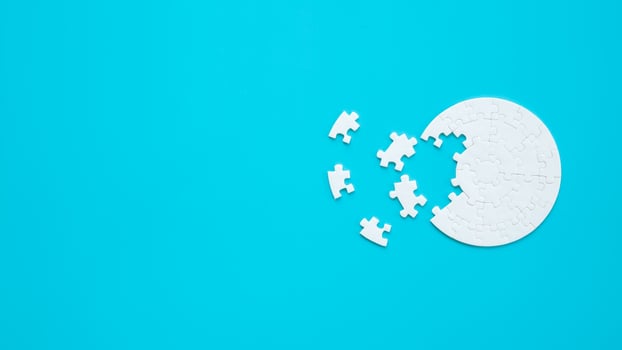 White part of jigsaw puzzle pieces on blue background. concepts of problem solving, business success, teamwork, Team playing jigsaw game incomplete, Texture photo with copy space for text