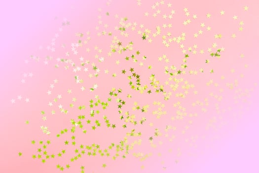 Gold star glitter on pink pastel background. Festive concept. Place for design. photo