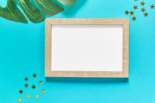 mockup frame with golden stars and monstera leaf photo