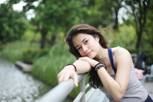 Young attractive woman doing stretching yoga exercise in the park. photo