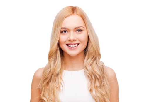 Blond beauty. Beautiful young blond hair woman looking at camera and smiling while standing isolated on white photo