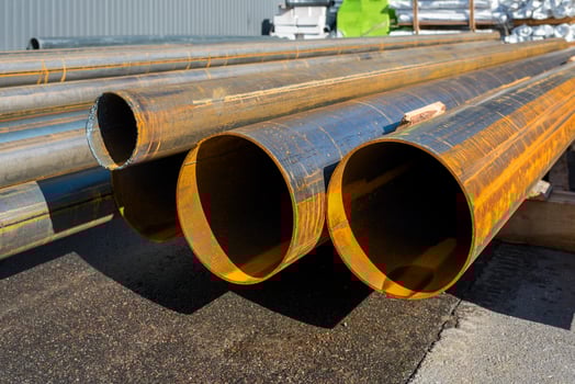 round metal pipes on asphalt, close-up of a cut, photo
