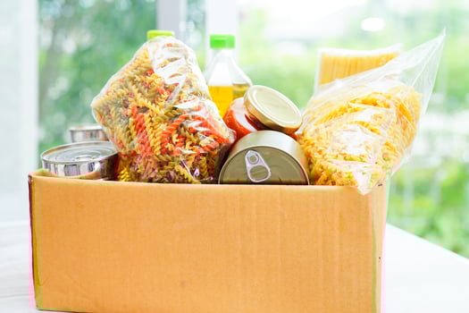 Foodstuffs in donation box for volunteer. photo
