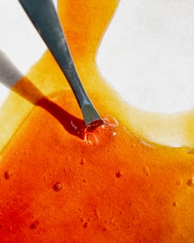 cannabis golden extract oil, metal stick and wax high thc photo