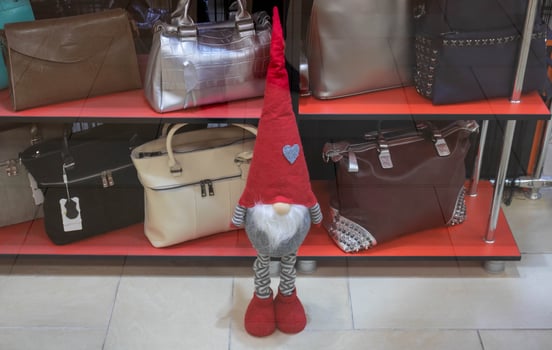 In the shop window bags and a dwarf in a pointed red hat photo
