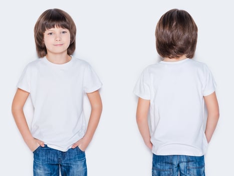 Advertising your brand. Front and rear view of little boy holding hands in pockets while standing against white background photo