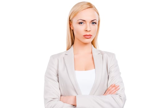 Confident businesswoman. Confident mature businesswoman keeping arms crossed while standing against white background photo