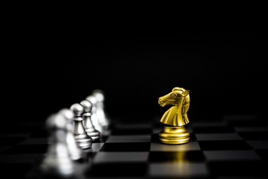 Chess game gold and silver on black background. photo