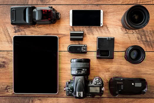 Photo equipment. Top view of diverse personal equipment for photographer laying on the wooden grain