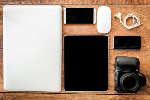 Up to date technology. Top view of diverse personal accessory laying on the wooden grain photo