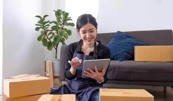 Starting small businesses SME owners female entrepreneurs Use a laptop or notebook to receive and review orders online to prepare to pack boxes, sell to customers, SME online business ideas. photo