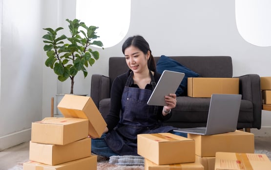 Starting small businesses SME owners female entrepreneurs Use a laptop or notebook to receive and review orders online to prepare to pack boxes, sell to customers, SME online business ideas. photo