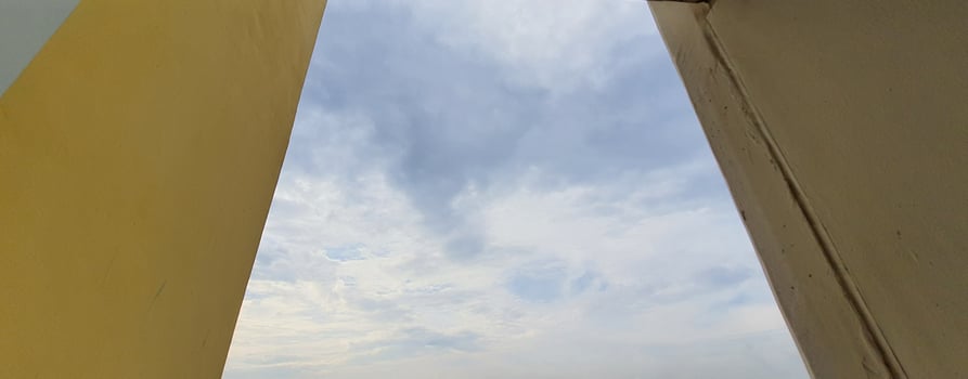 View of the sky between the building columns. photo