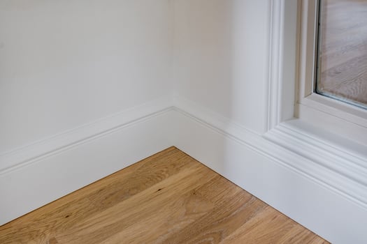 Detail of corner flooring with intricate crown molding and plinth. photo